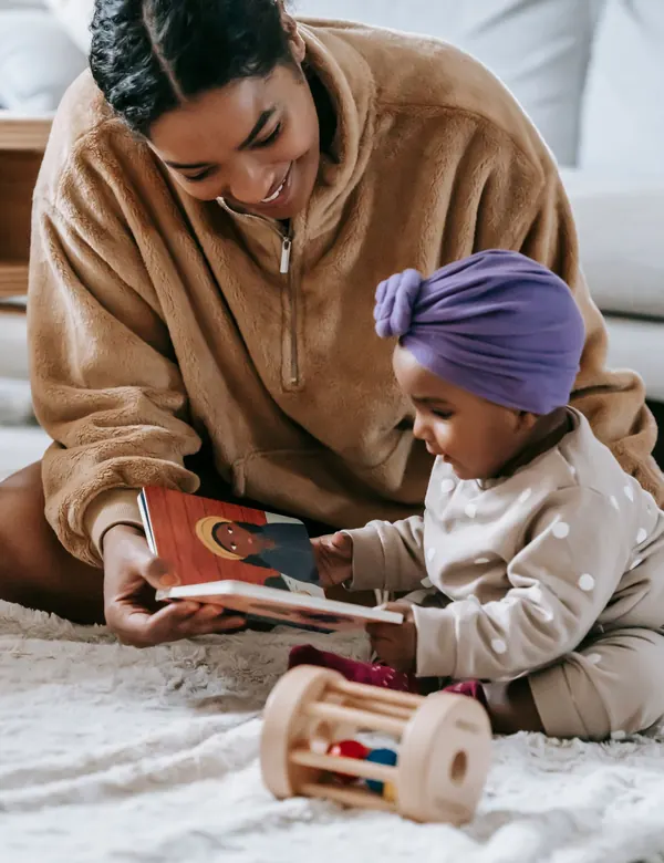 A parent sharing a picture book with a toddler